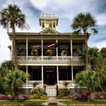 Urban Gardens - White Painted Structure With Green Palm Trees in the Front