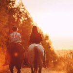 Car-Free Zones - Children riding stallions in countryside at bright sundown