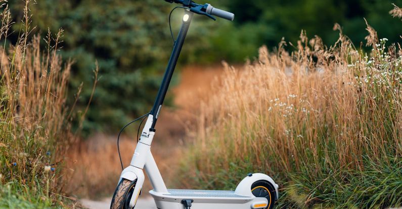 Sustainable Transportation - Photo of a Electric Scooter Standing on a Rural Side Way
