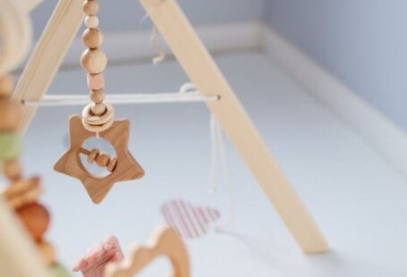 Tiny Homes - Cute toddler playing with wooden rattle