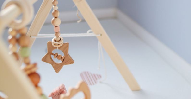 Tiny Homes - Cute toddler playing with wooden rattle