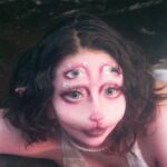 Emerging Markets - A woman in a white dress laying in the water