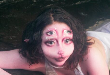 Emerging Markets - A woman in a white dress laying in the water