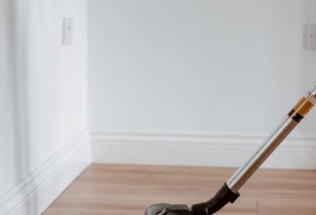 Property Maintenance - Modern vacuum cleaner washing floor in flat