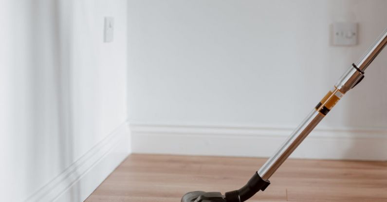 Property Maintenance - Modern vacuum cleaner washing floor in flat