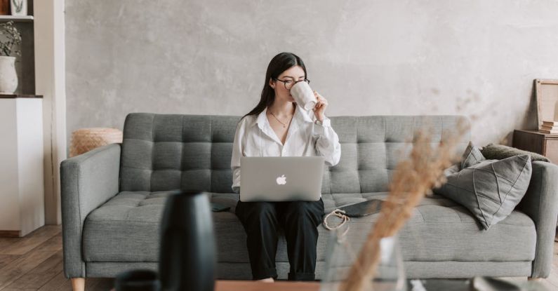 Smart Home Technologies - Woman Drinking Coffee While Working With Laptop