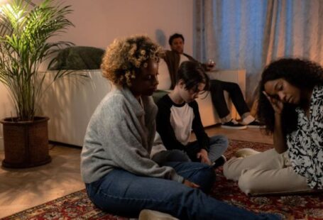 Economic Diversity - A Family Sitting on the Floor Having Problems