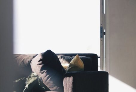 Equitable Access - Brown Couch Near Pillows and Mats