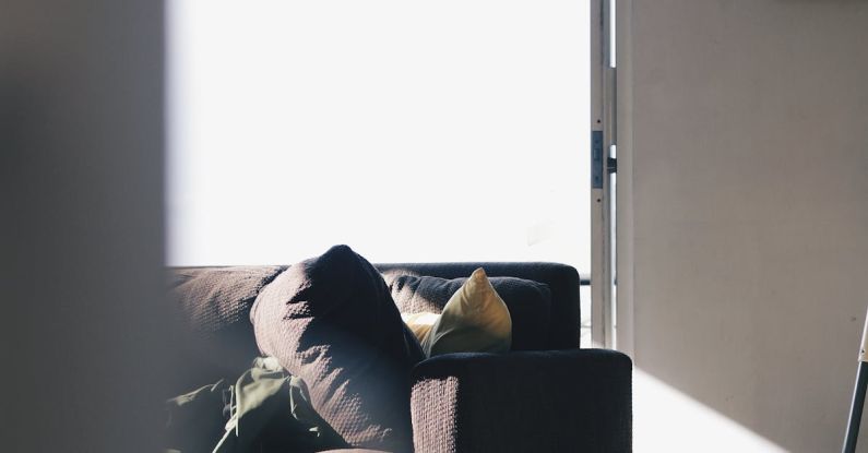Equitable Access - Brown Couch Near Pillows and Mats