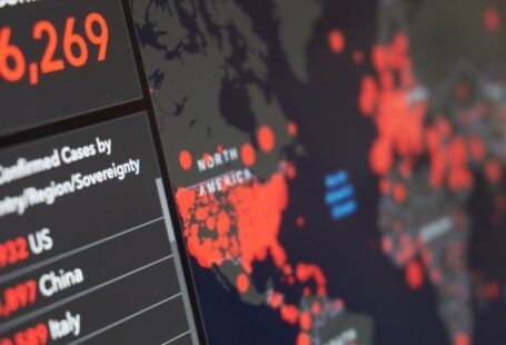 Community Outreach Programs - Blurred world map with total number of people infected by coronavirus and statistics of various countries