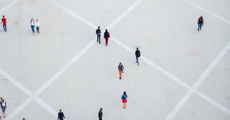 Public Squares - High angle citizens in casual wear walking on vast concrete ground in city square