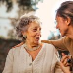 Child-Friendly Spaces - Joyful adult daughter greeting happy surprised senior mother in garden