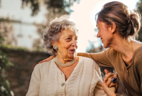 Child-Friendly Spaces - Joyful adult daughter greeting happy surprised senior mother in garden