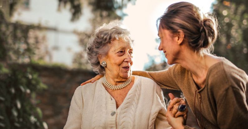 Child-Friendly Spaces - Joyful adult daughter greeting happy surprised senior mother in garden