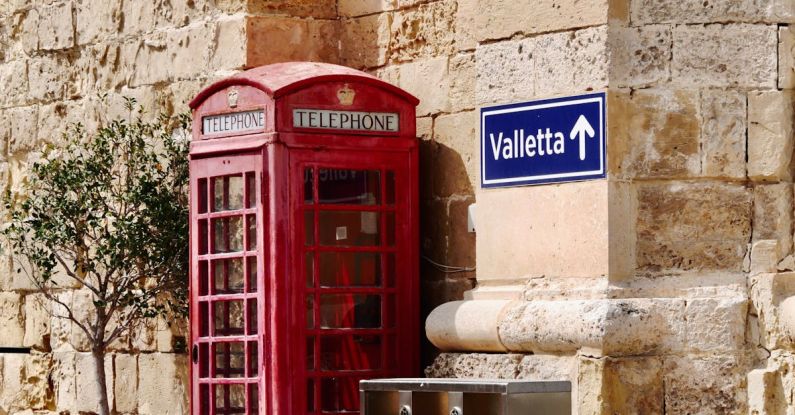 Recycling Programs - A red telephone booth next to a red telephone box