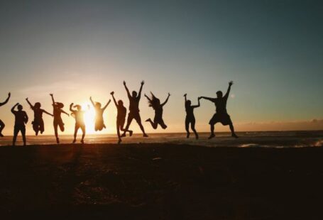 Community Initiatives - Silhouette Photography of Group of People Jumping during Golden Time