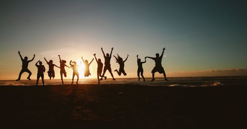 Community Initiatives - Silhouette Photography of Group of People Jumping during Golden Time